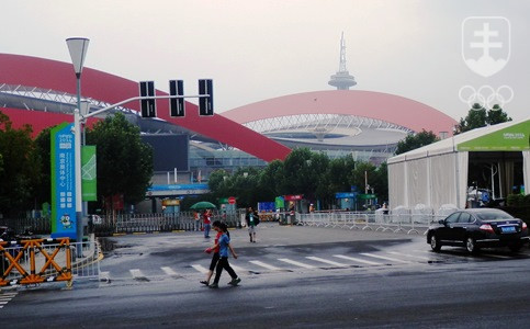 Štvrtkový upršaný pohľad na olympijský štadión. V čaši viditeľnej vpredu sa v sobotu rozhorí olympijský oheň. FOTO: ĽUBOMÍR SOUČEK